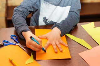 Child trace around a hand on paper with crayons. A simple drawing of a child's hand. Trace child palm. Hand Tracing. Children's creativity. Child trace around a hand on paper with crayons. A simple drawing of a child's hand. Trace child palm. Hand Tracing. Children's creativity.