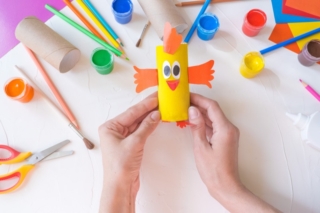 Holiday easy DIY craft idea for kids. Toilet paper roll tube toy chick baby on a white background with colored paper.. Creative Easter decoration eco-friendly, reuse, recycle, zero waste handmade Holiday easy DIY craft idea for kids. Toilet paper roll tube toy chick baby on a white background with colored paper.. Creative Easter decoration eco-friendly, reuse, recycle, zero waste handmade