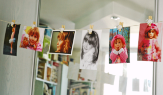 Child,Photographs,Hanging,On,A,Clothesline,In,Room