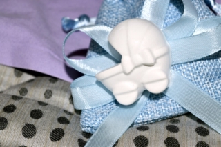 blue bag with confetti and decoration of a cradle shape