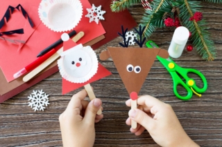 A,Child,Is,Holding,Christmas,Santa,And,Reindeer,Stics,Puppets. A,Child,Is,Holding,Christmas,Santa,And,Reindeer,Stics,Puppets.