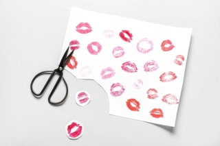Paper,Sheet,With,Lipstick,Kiss,Marks,And,Scissors,On,Grey Paper,Sheet,With,Lipstick,Kiss,Marks,And,Scissors,On,Grey